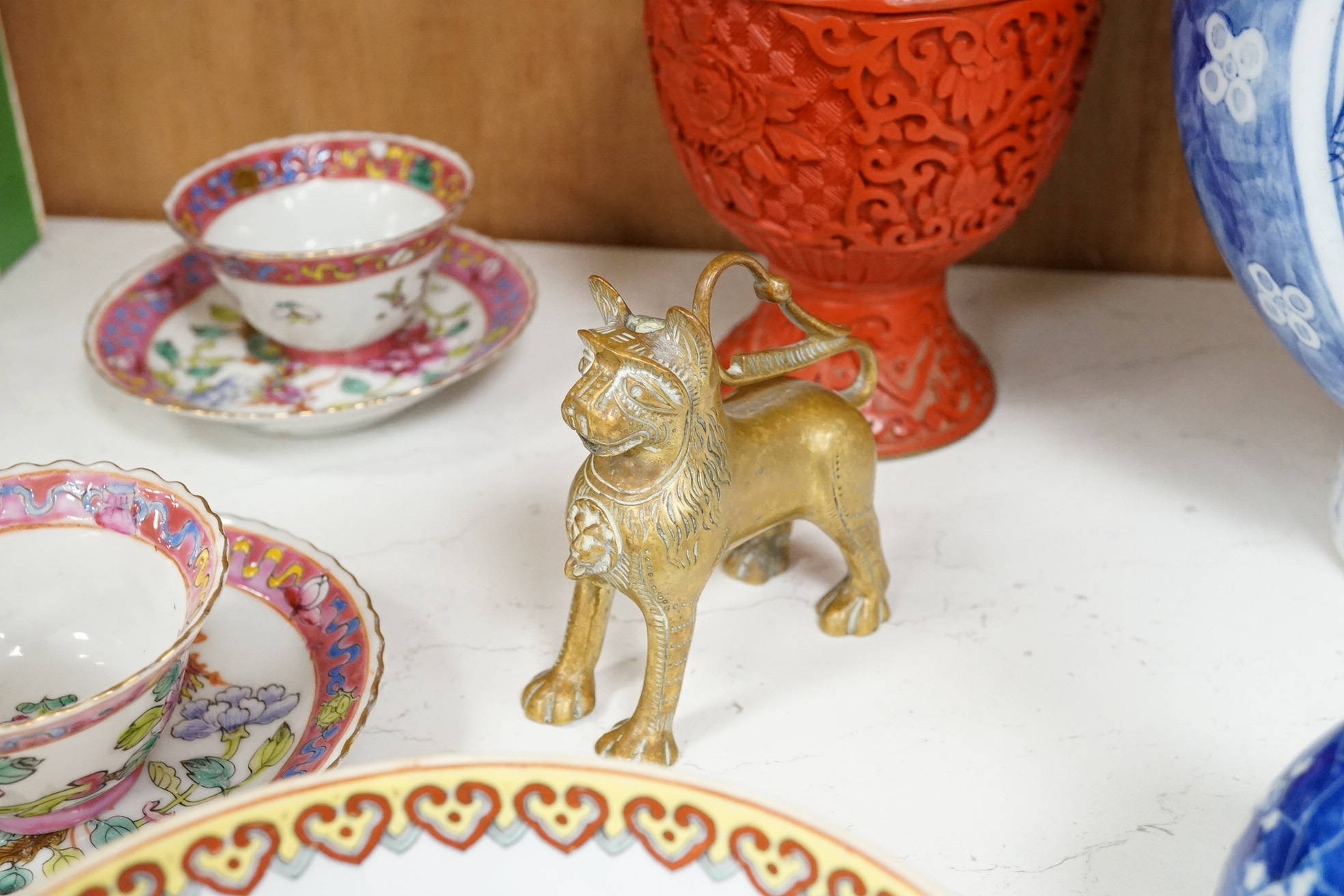 A group of mixed oriental porcelain and metalware to include a Japanese satsuma vase, cinnabar lacquer vase and blue and white teapot, largest 32cm high.